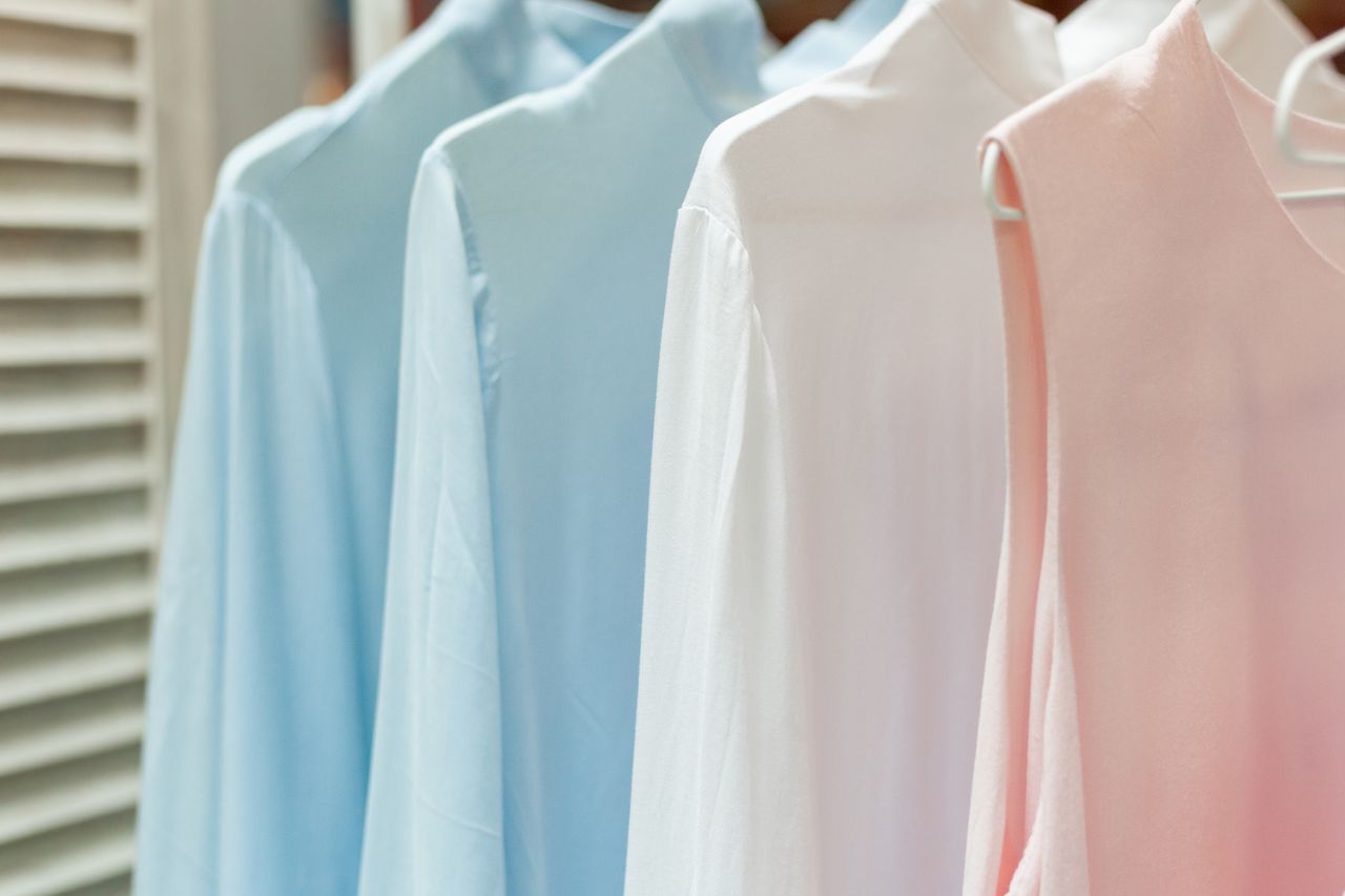why-choose-us Row of different female apparel made of natural materials and hanging on racks in boutique