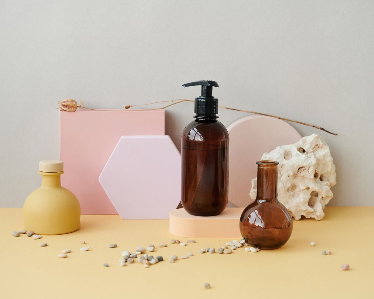 gallery-6 Aesthetic composition of bottles with pastel geometric shapes and pebbles, perfect for product display.