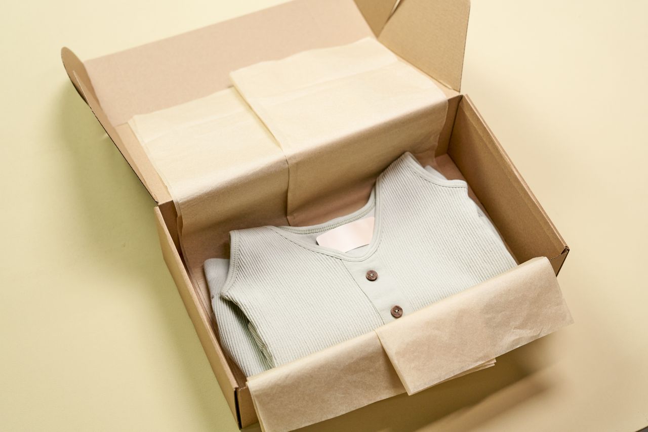 gallery-5 Sustainable wardrobe piece neatly packed in recyclable materials for an eco-conscious lifestyle.